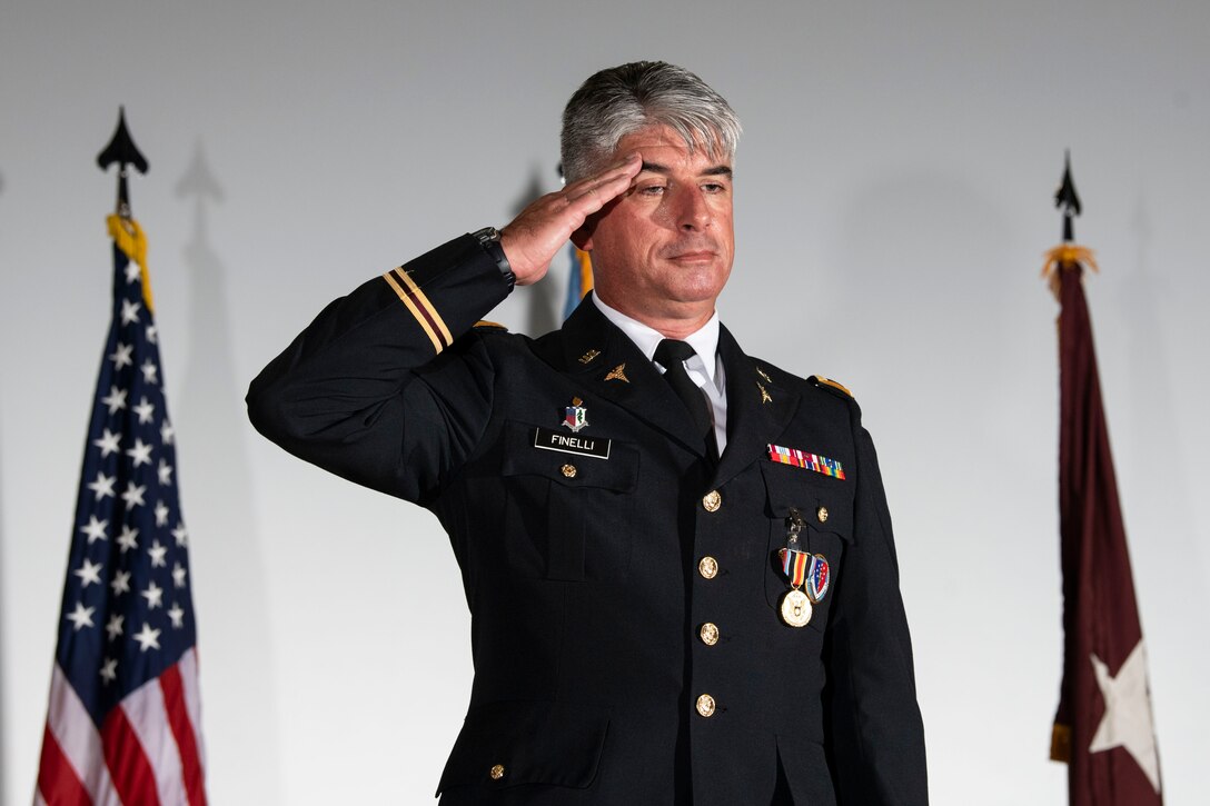 U.S. Army Col. Louis Finelli, outgoing Armed Forces Medical Examiner System  director, presents his final salute during a change of directorship ceremony at Dover Air Force Base, Delaware, Oct. 21, 2020. AFMES provides the Department of Defense and other federal agencies comprehensive forensic investigative services, to include forensic pathology, DNA forensics, forensic toxicology and medical mortality surveillance. (U.S. Air Force photo by Senior Airman Christopher Quail)