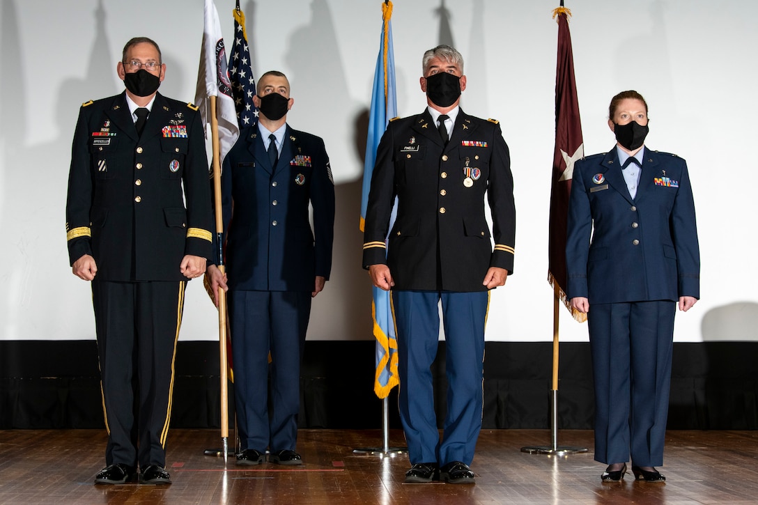 Senior leaders stand at attention during an Armed Forces Medical Examiner System change of directorship ceremony at Dover Air Force Base, Delaware, Oct. 21, 2020. AFMES is committed to being the Department of Defense’s leader in providing medical-legal services and emerging technologies essential for the readiness, sustainability and survivability of U.S. service members. (U.S. Air Force photo by Senior Airman Christopher Quail)