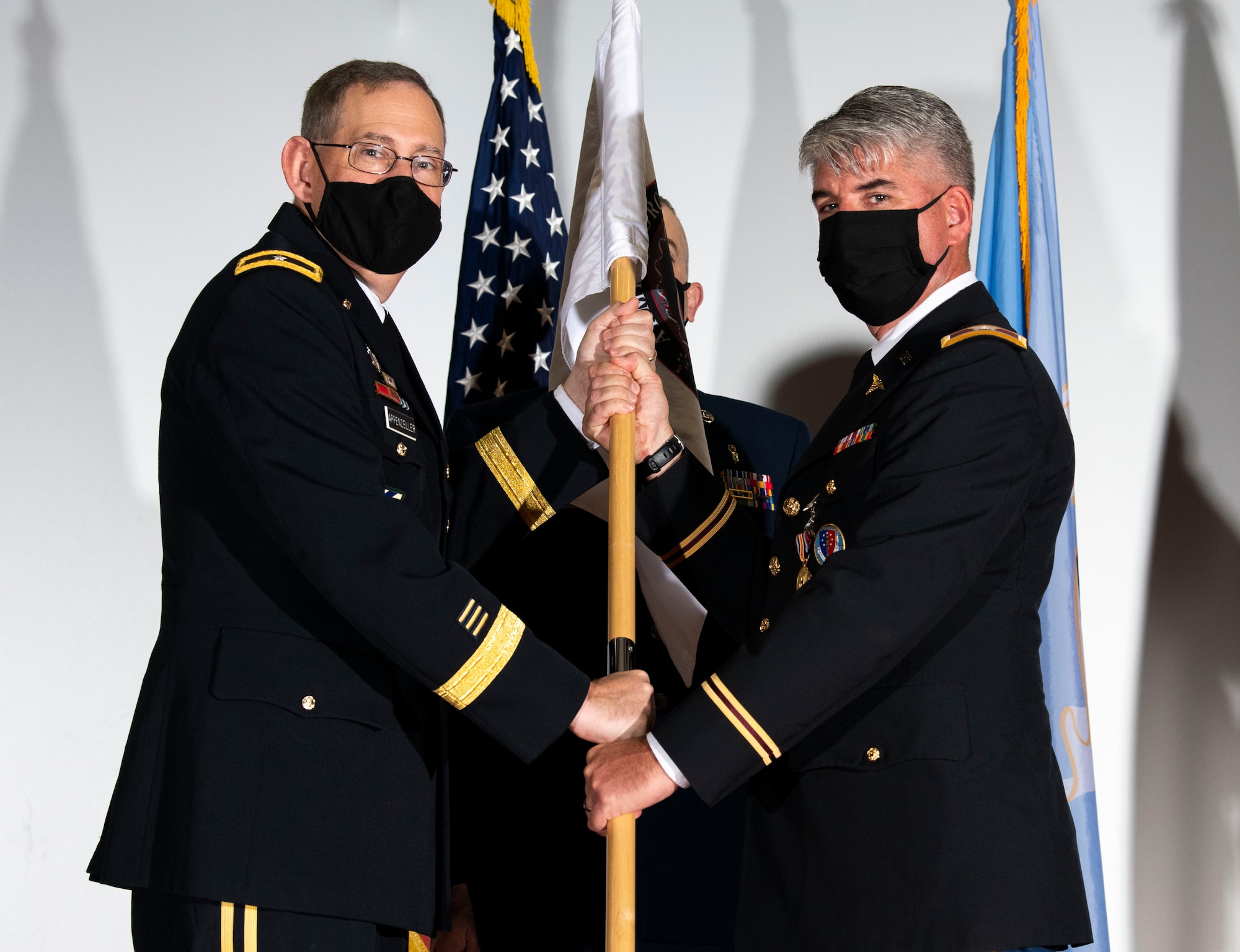 U.S. Army Brig. Gen. George Appenzeller (left), Defense Health Agency assistant director, presents the Armed Forces Medical Examiner System guidon to U.S. Army Col. Louis Finelli, outgoing AFMES director, during a change of directorship ceremony at Dover Air Force Base, Delaware, Oct. 21, 2020. AFMES provides the Department of Defense and other federal agencies comprehensive forensic investigative services, to include forensic pathology, DNA forensics, forensic toxicology and medical mortality surveillance. (U.S. Air Force photo by Senior Airman Christopher Quail)