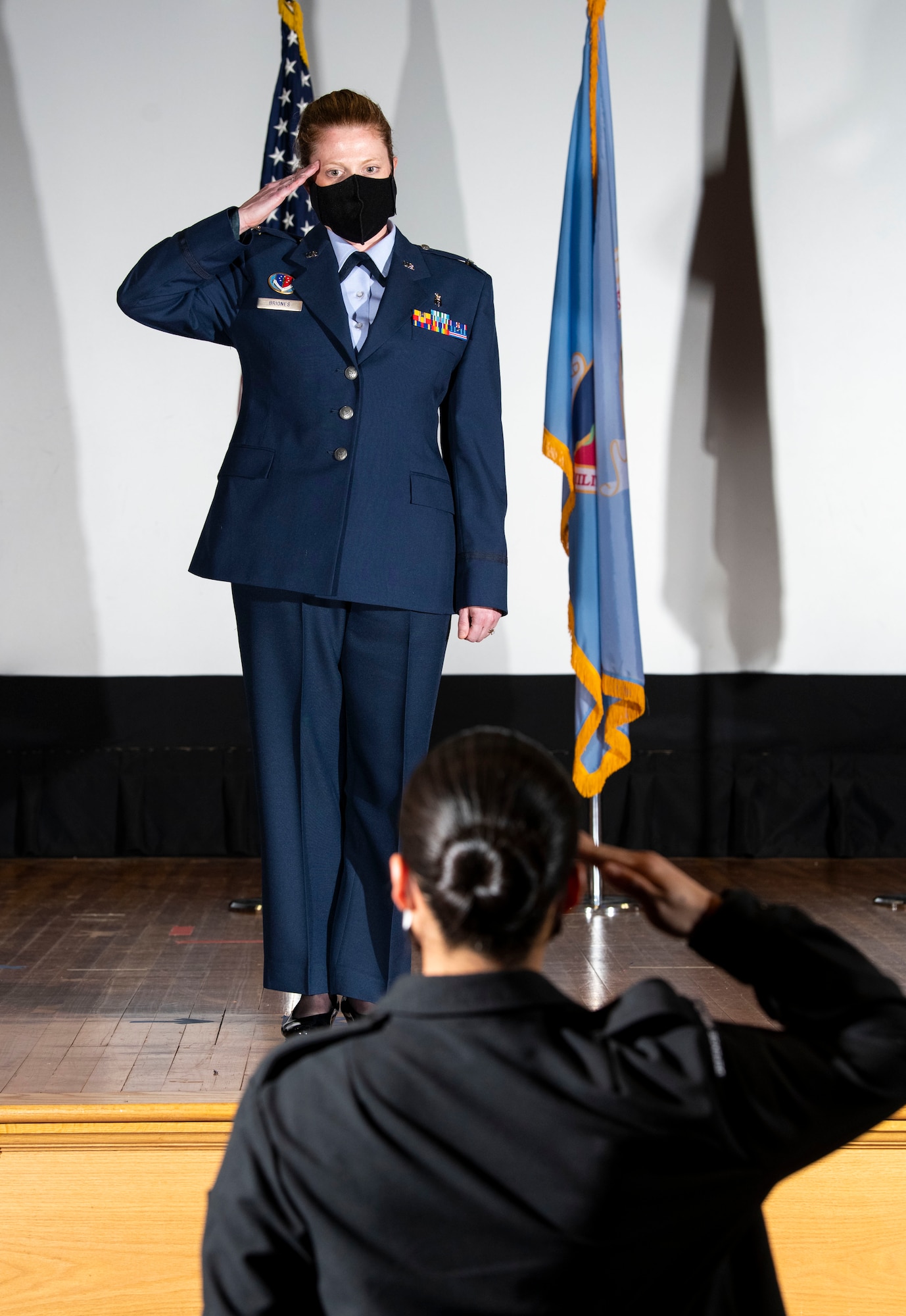 U.S. Air Force Col. Alice Briones, incoming Armed Forces Medical Examiner System director, presents her first salute during a change of directorship ceremony at Dover Air Force Base, Delaware, Oct. 21, 2020. AFMES provides the Department of Defense and other federal agencies comprehensive forensic investigative services, to include forensic pathology, DNA forensics, forensic toxicology and medical mortality surveillance. (U.S. Air Force photo by Senior Airman Christopher Quail)
