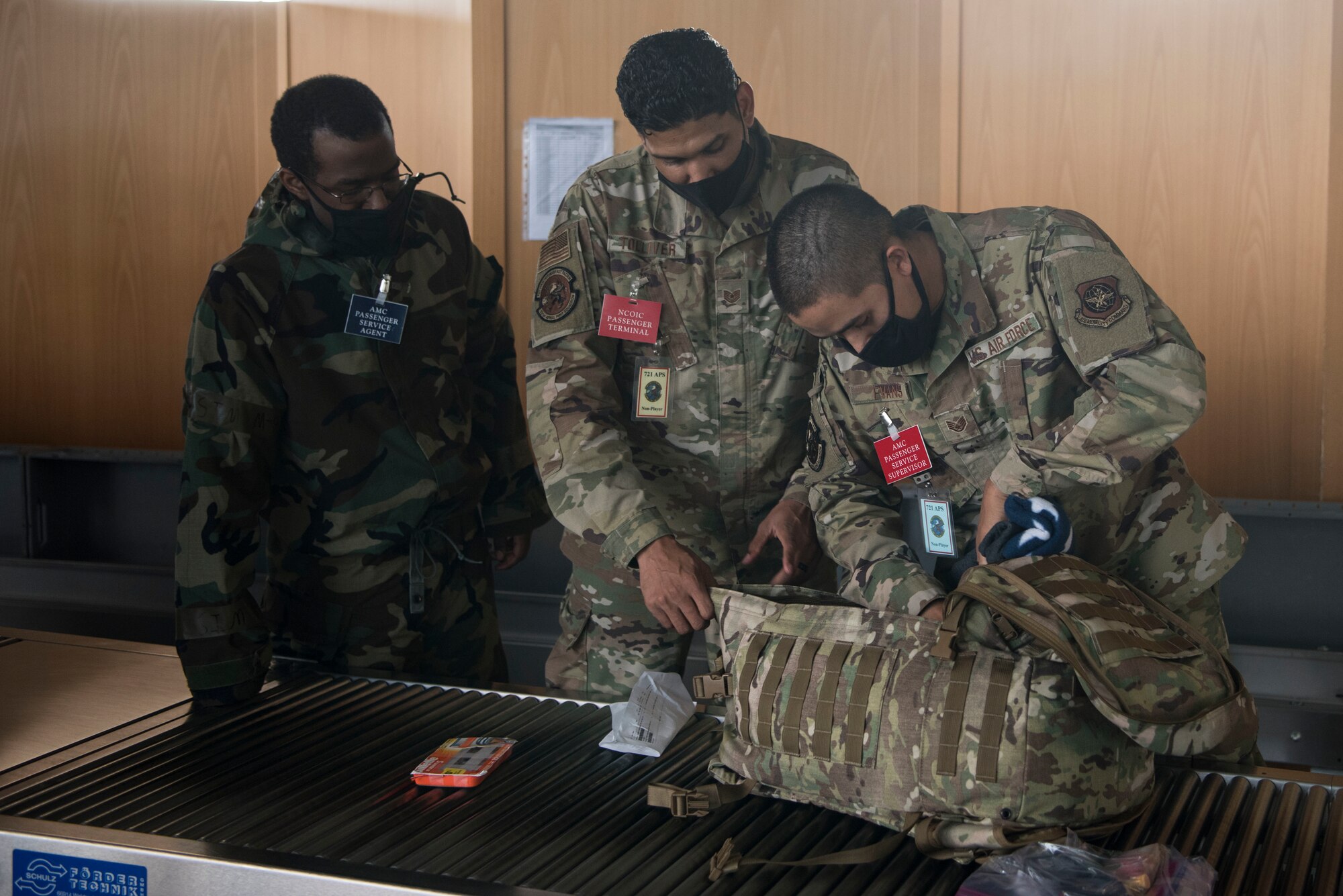 U.S. Air Force Airmen assigned to the 721st Aerial Port Squadron conduct a security bag check during exercise Nodal Lightning 20-2