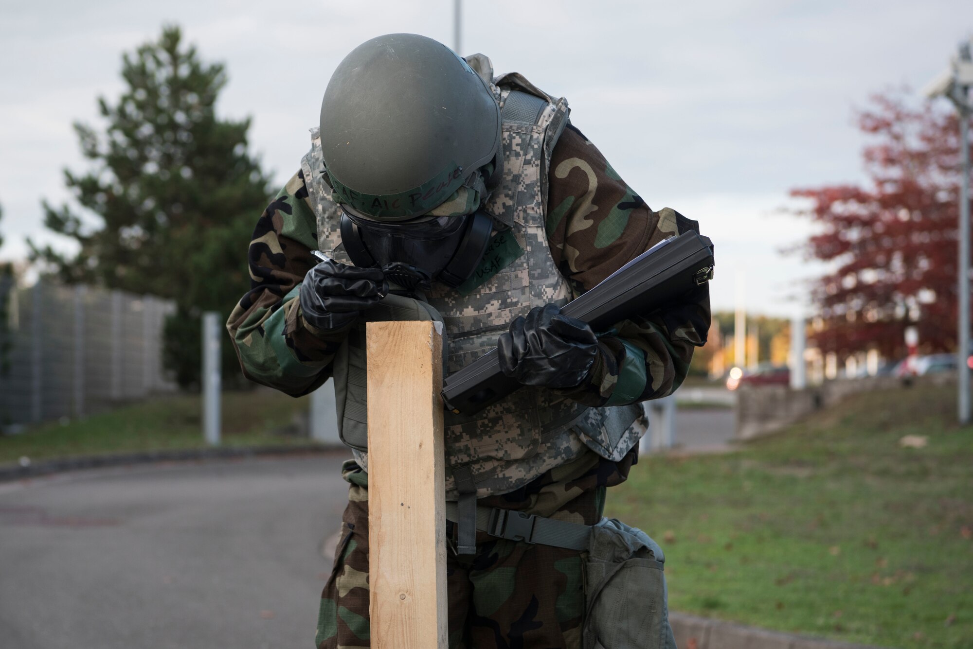 U.S. Air Force Airman 1st Class Kyle Pease, 721st Aerial Port Squadron passenger service agent, checks M-8 paper for contaminates during a post-attack reconnaissance sweep after a simulated attack during exercise Nodal Lightning 20-2