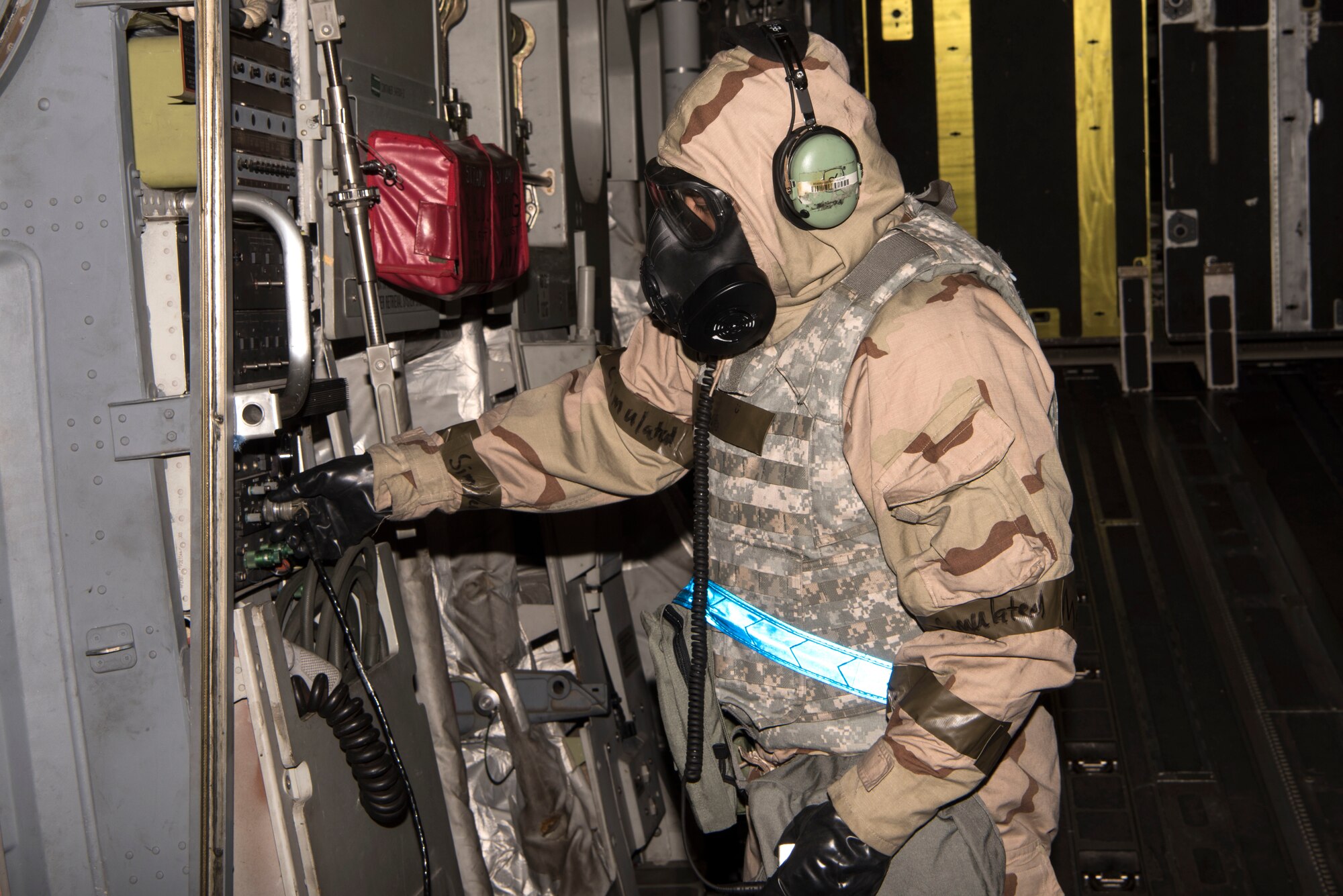 U.S. Air Force Senior Airman Joseph Umipeg, 721st Aircraft Maintenance Squadron crew chief, tests communication cables on a U.S. Air Force C-17 Globemaster III aircraft