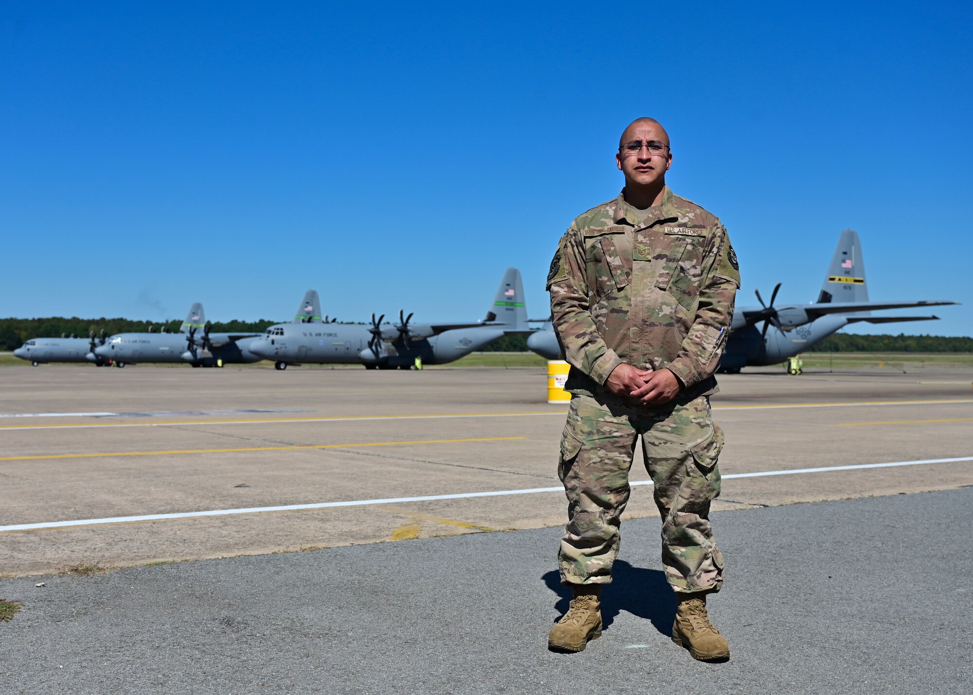 An Airman poses for a photo on the flight line.