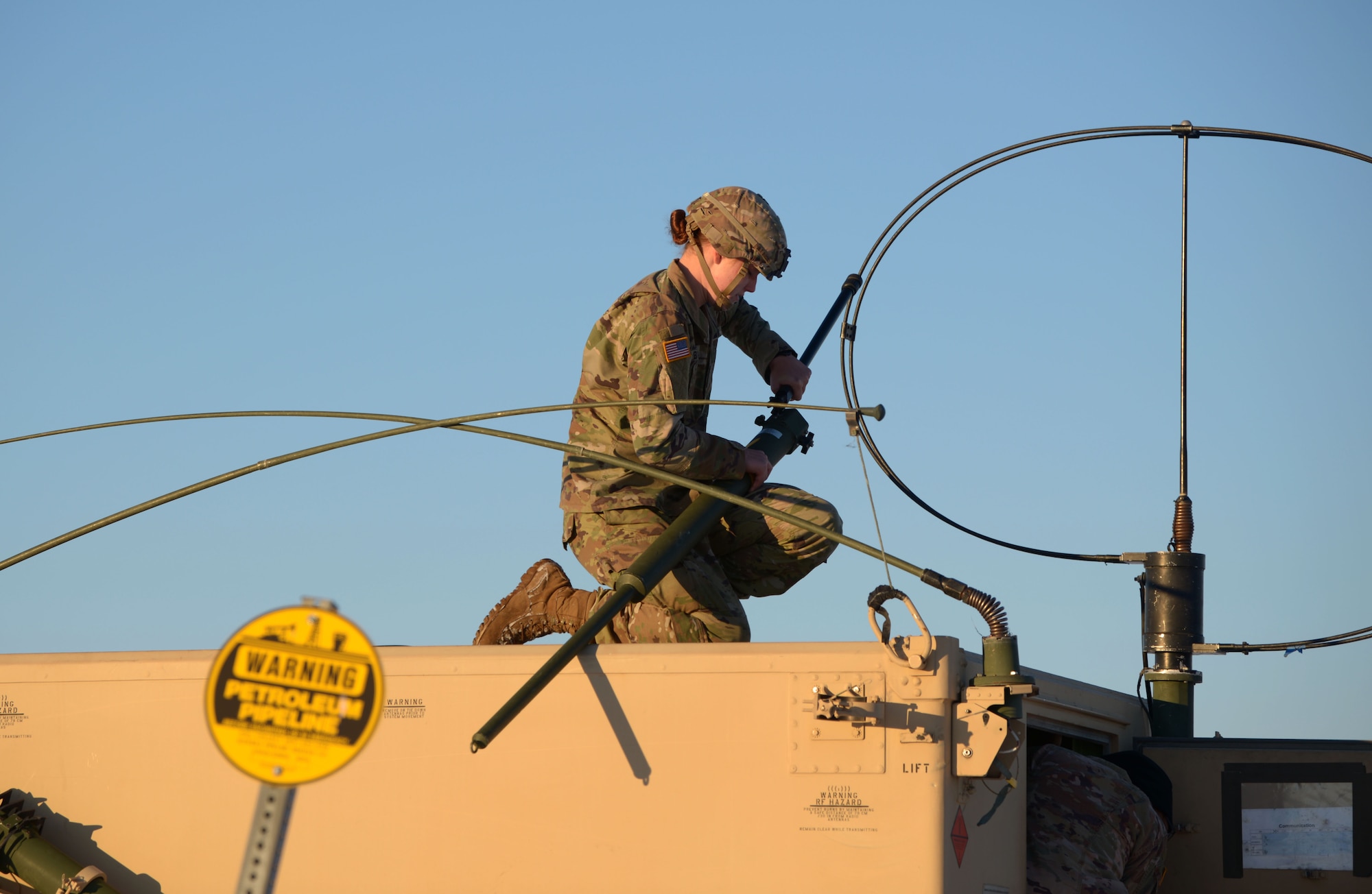 A U.S. Army Soldier fixes long-range radio equipment to a High Mobility Multipurpose Wheeled Vehicle at Fort Greely, Alaska, Oct. 22, 2020. Along with aerial training, RF-A features multiple ground elements that increase the overall readiness of the U.S. military. (U.S. Air Force photo by Senior Airman Beaux Hebert)