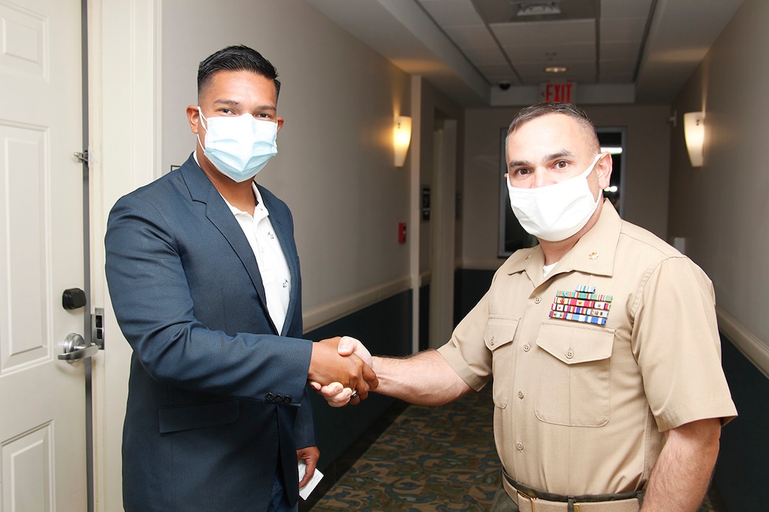 U.S. Marine Corps Maj. Carlo Brancato welcomes El Salvador Navy Lt. j.g. Max Antonio Orantes at Jacksonville, N.C., Oct. 13.