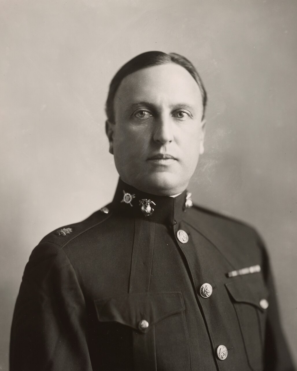 A man in uniform poses for a photo.