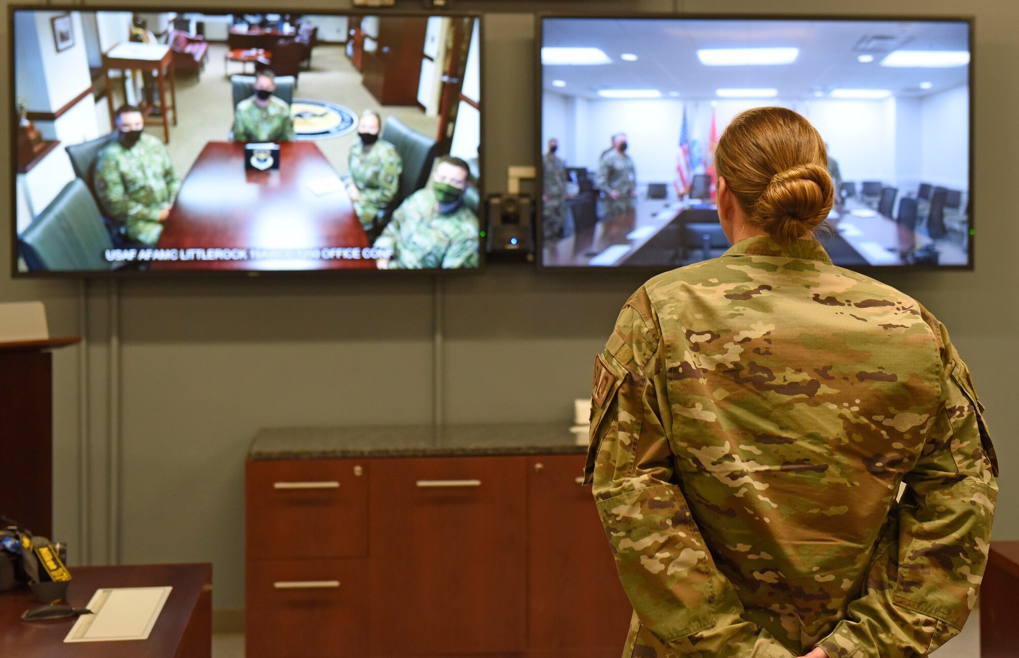 Airmen stands in front of Video Teleconference Center