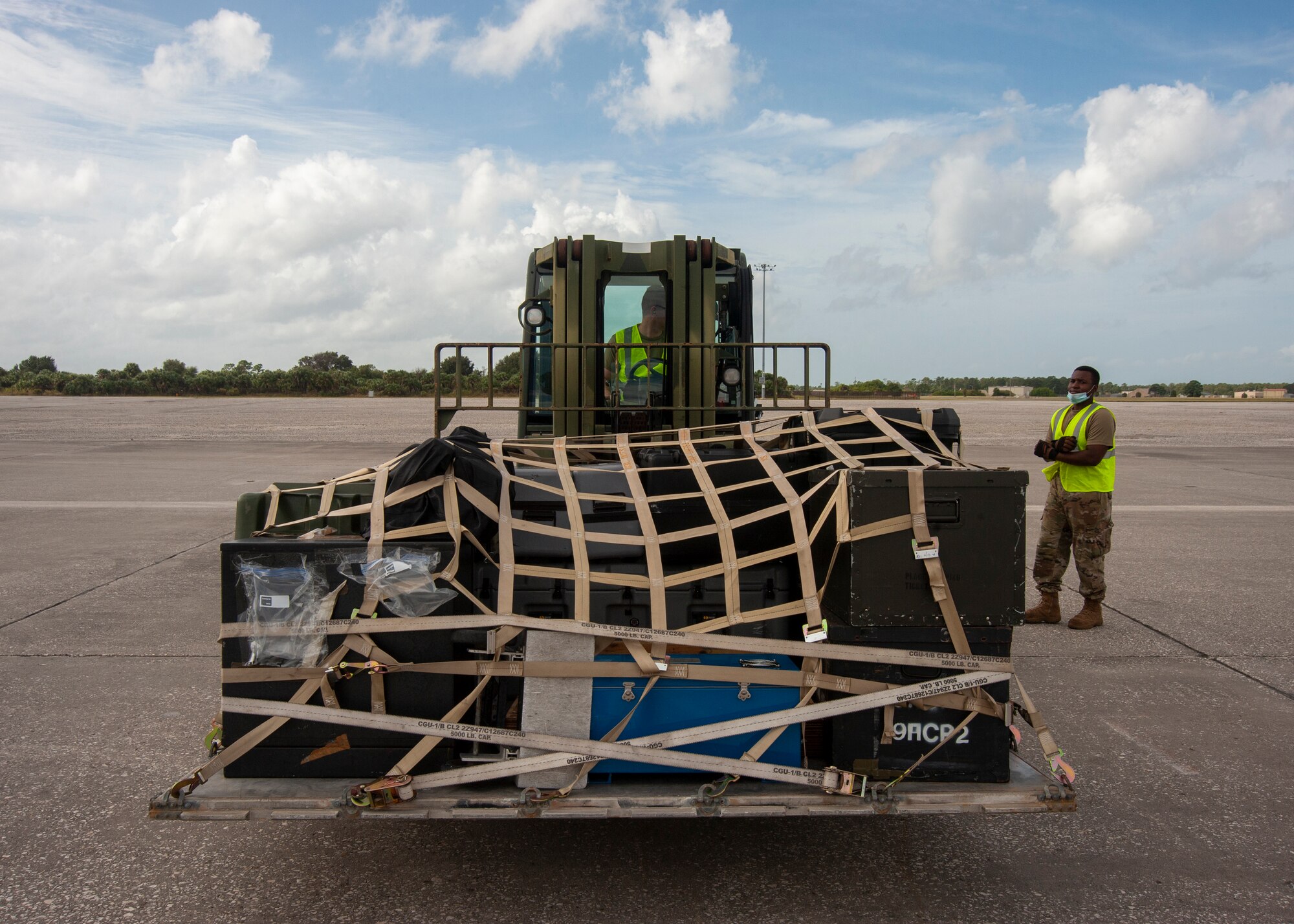 Airmen from the 6th Logistics Readiness Squadron at MacDill Air Force Base, Fla., use a 10K Standard Forklift, Oct. 21, 2020, to set a pallet on the flightline. The pallet contained deployment gear for an exercise to test the global mobility of the crew. (U.S. Air Force Photo by A1C David D. McLoney)