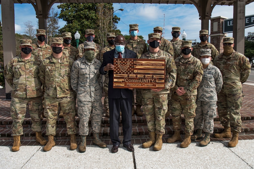 The Community Resource Center Summerville presents members of the 437th Aerial Port Squadron with a plaque during a recognition ceremony, Oct. 23, 2020, in Summerville, S.C. Members of both Joint Base Charleston and the community came together to honor the volunteer efforts of these Airmen who have been instrumental in the massive food giveaways orchestrated by the Summerville YMCA and the Community Resource Center Summerville where they helped provide over 60,000 boxes of groceries and 2,400 kits of school supplies to Dorchester County Residents since the beginning of the pandemic.  (Photo by Staff Sgt. Tenley Long)