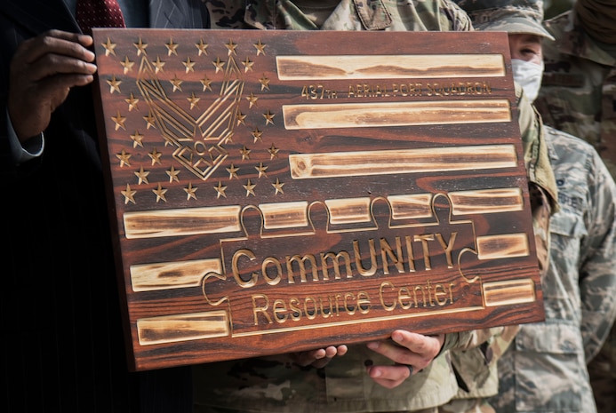 The Community Resource Center Summerville presents members of the 437th Aerial Port Squadron with a plaque during a recognition ceremony, Oct. 23, 2020, in Summerville, S.C. Members of both Joint Base Charleston and the community came together to honor the volunteer efforts of these Airmen who have been instrumental in the massive food giveaways orchestrated by the Summerville YMCA and the Community Resource Center Summerville where they helped provide over 60,000 boxes of groceries and 2,400 kits of school supplies to Dorchester County Residents since the beginning of the pandemic.  (Photo by Staff Sgt. Tenley Long)