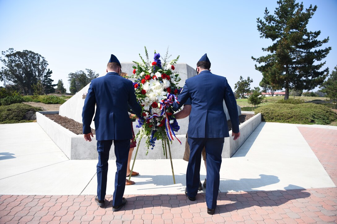 30th Civil Engineer Squadron Explosive Ordinance Disposal Airmen and family members lay a wreath during the 10 year anniversary wreath laying ceremony honoring the life of Senior Airman Daniel Johnson Oct. 4, 2020, at Vandenberg Air Force Base, Calif. Johnson was killed on duty during a deployment to Kandahar Airfield, Afghanistan, in support of Operation Locating Bravo in 2010. Operating from Combat Outpost Belanday, he cleared lines of communication, enabled freedom of maneuver and ensured coalition and local national safety. He was single-handedly responsible for saving the life of an Afghan National Army Soldier, who injured by a concealed booby-trap.   (U.S. Space Force photo by Senior Airman Hanah Abercrombie)