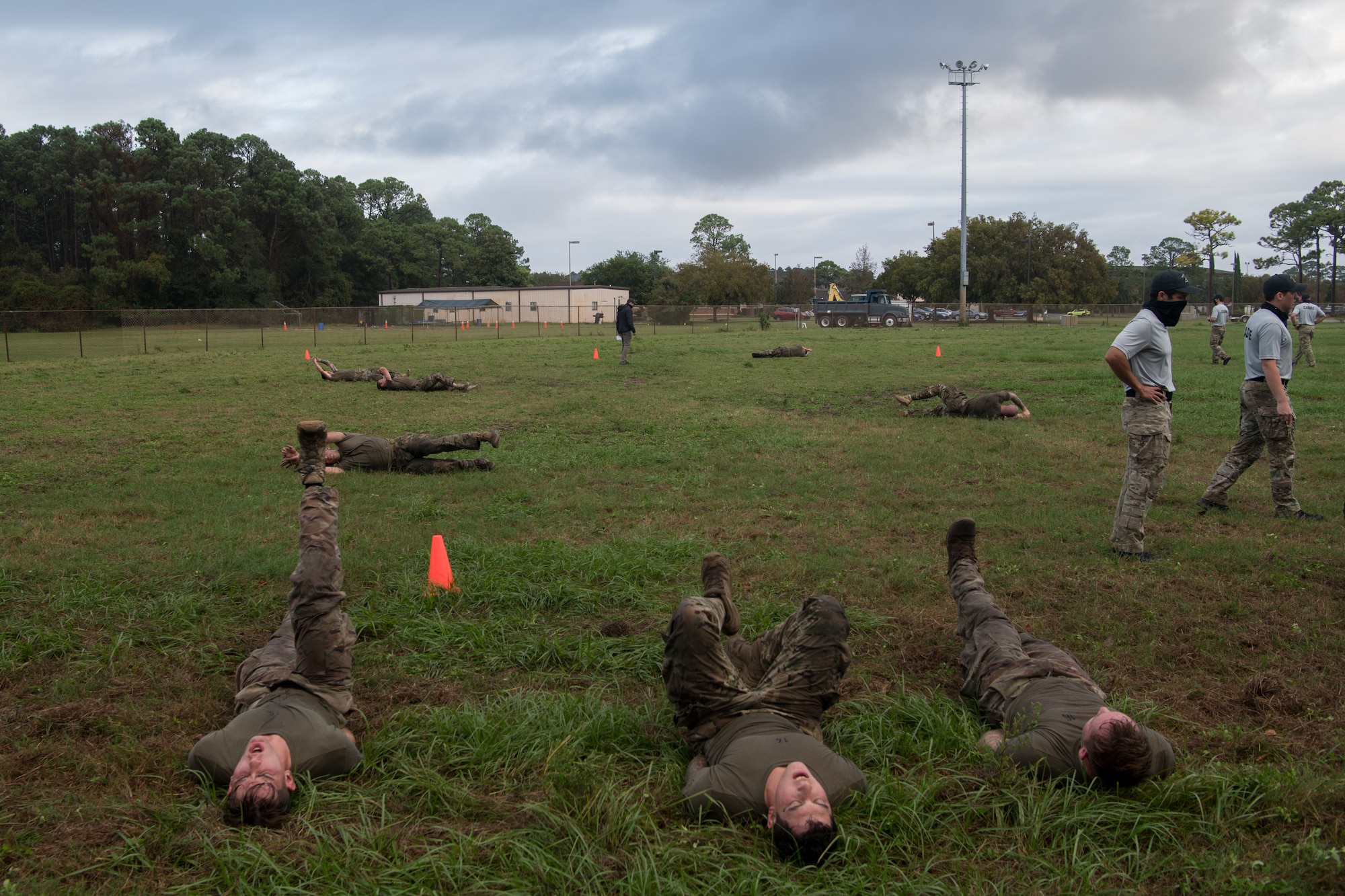 Special Tactics tactical air control party candidates participate in “grass and gorillas” during assessment by laying on their backs and kicking their legs into the air in various positions.