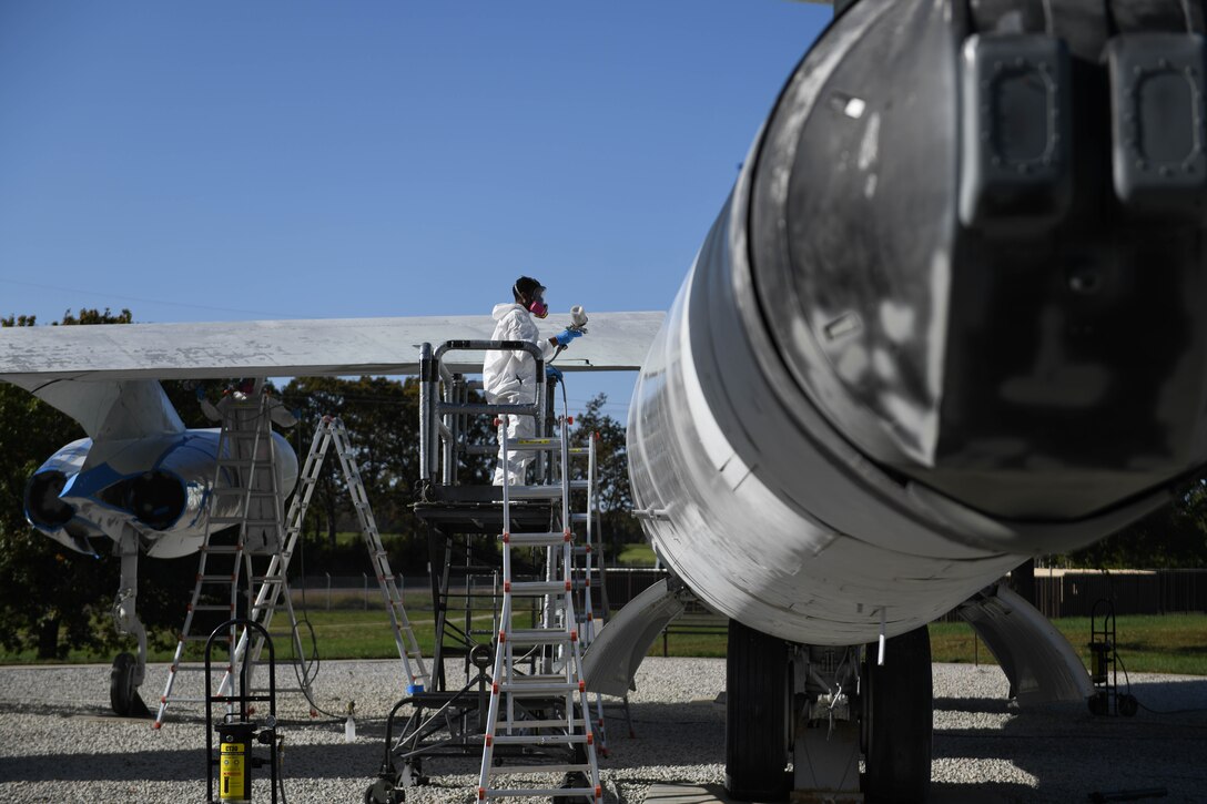 U.S. Air Force Airman 1st Class Tracy Bethea, 509th Maintenance Squadron low-observable maintenance technician, paints the side of the Boeing B-47 Stratojet hull on display at Whiteman Air Force Base, Missouri, Oct. 13, 2020. The static aircraft experienced wear over the past 10 years and was in need of cosmetic repair and maintenance. (U.S. Air Force photograph by Airman 1st Class Devan Halstead)