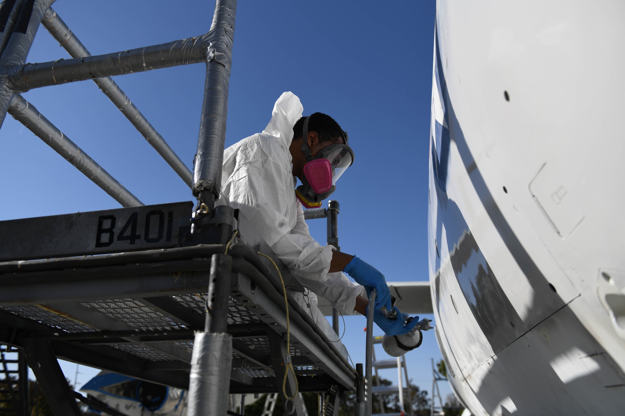 U.S. Air Force Airman 1st Class Tracy Bethea, 509th Maintenance Squadron low-observable maintenance technician, paints the side of the Boeing B-47 Stratojet hull on display at Whiteman Air Force Base, Missouri, Oct. 13, 2020. The aircraft’s restoration had to meet the standards set by the United States Air Force Museum. (U.S. Air Force photograph by Airman 1st Class Devan Halstead)