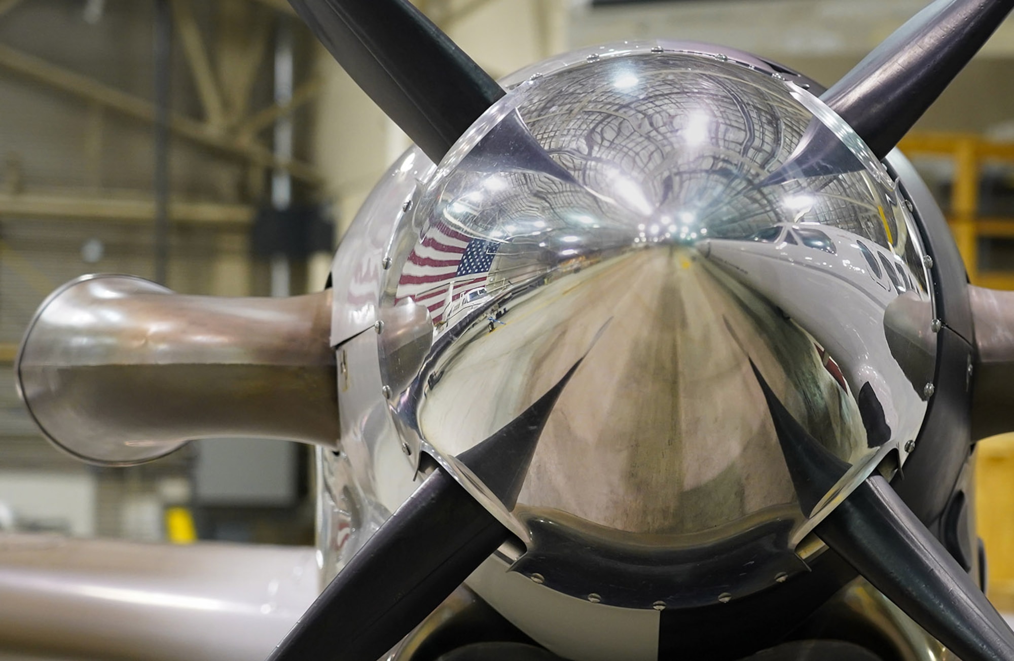 An America flag is reflected in one of the turboprop nose cones of a C-12F Huron, Oct. 22, 2020, in a hangar on Joint Base Elmendorf-Richardson, Alaska. The Huron is a versatile twin-engine turboprop primarily used by the military for limited passenger and light cargo transport, embassy support, and medical evacuation if needed.