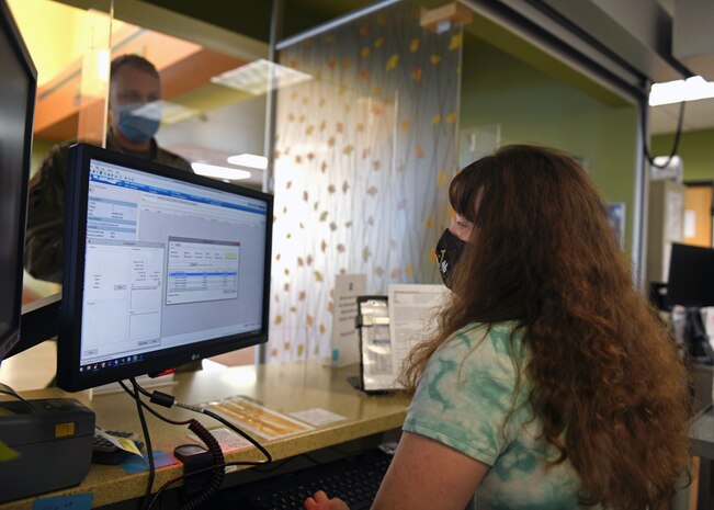 Sherry Freeberg, 9th Healthcare Operations Squadron certified pharmacy technician, assists a patient, Oct. 23, 2020, at Beale Air Force Base, California. Military members work side-by-side with civilians in a seamless operation to provide Airman and their families with the medicine they need. (U.S. Air Force photo by Airman 1st Class Luis A. Ruiz-Vazquez)