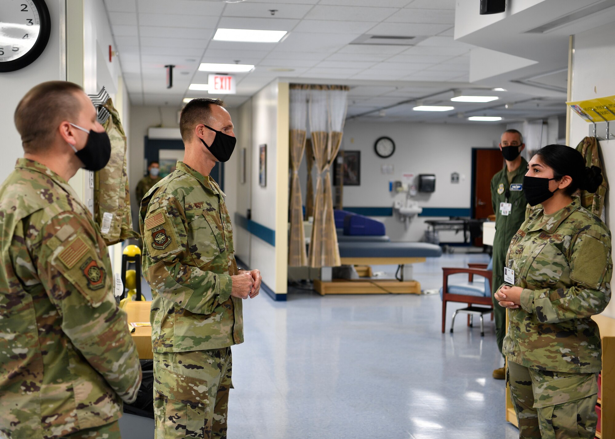 U.S. Air Force Brig. Gen. Norman West, Air Mobility Command surgeon general, and Chief Master Sgt. David Little, AMC medical enlisted force chief, receive a briefing from Airman 1st Class Yolanda Pena, 87th Operational Medical Readiness Squadron Physical Therapist technician, at the 87th Medical Group on Joint Base McGuire-Dix-Lakehurst, N.J., Oct. 22, 2020. With physical training tests on hold, Pena briefed West and Little what the Human Performance flight is doing to ensure profiles stay down until testing resumes. During their visit, West and Little spoke to members of the 87th MDG to learn about their mission and to answer concerns and questions members had during this altered work environment due to COVID-19. (U.S. Air Force photo by Staff Sgt. Jake Carter)