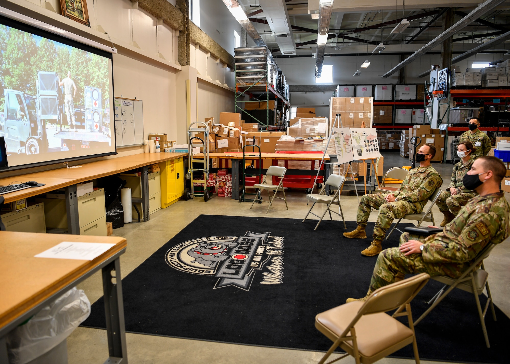 U.S. Air Force Brig. Gen. Norman West, Air Mobility Command surgeon general, and Chief Master Sgt. David Little, AMC medical enlisted force chief, receive a briefing from the 87th Medical Support Squadron Logistics Support team at the 87th Medical Group on Joint Base McGuire-Dix-Lakehurst, N.J., Oct. 22, 2020. Medical logistics ensures that all Air Force medical facilities have the medications, supplies and equipment needed to treat service members and their families. During their visit, West and Little spoke to members of the 87th MDG to learn about their mission and to answer concerns and questions members had during this altered work environment due to COVID-19. (U.S. Air Force photo by Staff Sgt. Jake Carter)