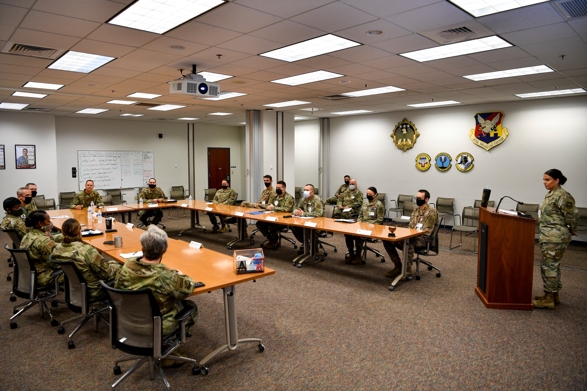 U.S. Air Force Brig. Gen. Norman West, Air Mobility Command surgeon general, and Chief Master Sgt. David Little, AMC medical enlisted force chief, receive a presentation from the 87th Medical Group leadership on Joint Base McGuire-Dix-Lakehurst, N.J., Oct. 22, 2020. The presentation provided West and Little the layout and statistics of how the 87th MDG has operated the last few years. During their visit, West and Little spoke to members of the 87th MDG to learn about their mission and to answer questions members had during this altered work environment due to COVID-19. (U.S. Air Force photo by Staff Sgt. Jake Carter)