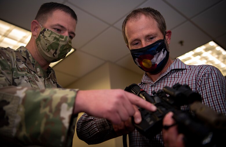 Tech. Sgt. Brian Litney, 50th Security Forces Squadron noncommissioned officer in charge of combat arms, left, instructs Steven Hargrove, 50th Logistics Readiness Flight support agreements manager, on how to clear a firearm Oct. 22, 2020, at Schriever Air Force Base, Colorado. According to the University of California, Davis Health, there were 39,740 firearm deaths in the U.S. in 2018. (U.S. Space Force photo by Airman 1st Class Jonathan Whitely)
