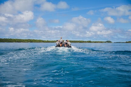 Marines and Sailors assigned to Task Force Ellis and Commander, Task Force 75 utilize a combat rubber raiding craft before conducting open-circuit dive operations.