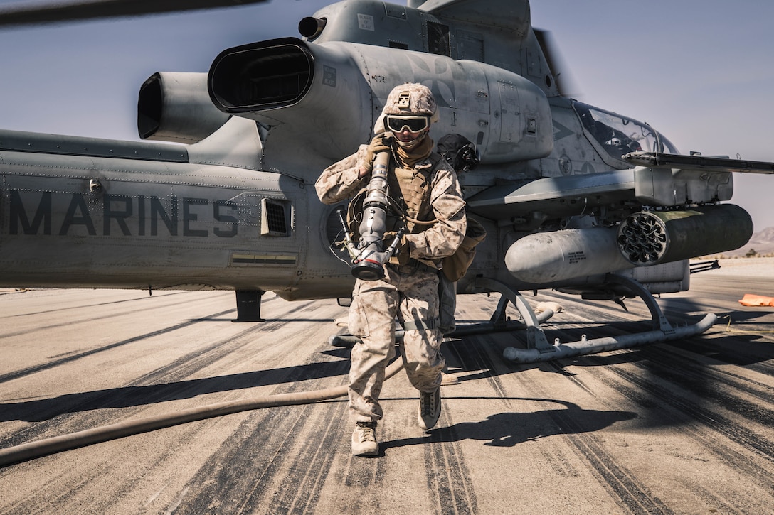 Marine refuels AH-1Z Viper at forward arming and refueling point during Integrated Training Exercise 1-21 at Marine Air Ground Combat Center Twentynine Palms, California, October 16, 2020 (U.S. Marine Corps/Zachary Zephir)