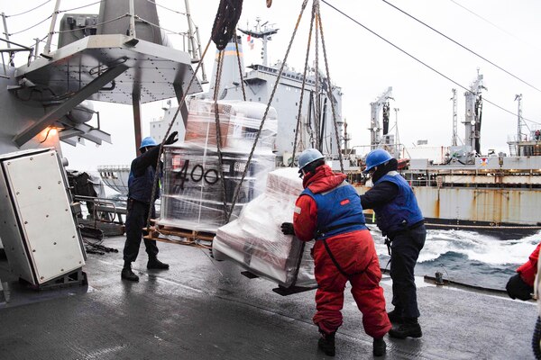 201022-N-TC847-1252 BARENTS SEA (Oct. 22, 2020) Sailors aboard the Arleigh Burke-class guided-missile destroyer USS Ross (DDG 71) recieve pallets of supplies during a replenishment at sea with USNS Laramie (T-AO-203), Oct. 22, 2020. Ross is currently on its tenth Forward Deployed Naval Forces-Europe (FDNF-E) patrol in the U.S. 6th Fleet area of operations in support of U.S. national security interests in Europe and Africa. (U.S. Navy photo by Mass Communication Specialist Seaman Christine Montgomery/released)