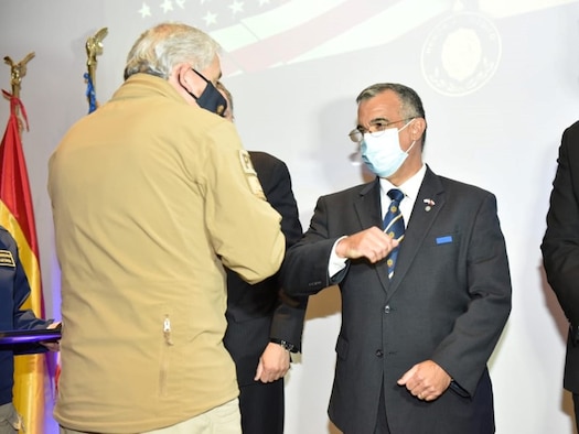 Hector Espinoza, Director General of the Policia de Investigaciones, left, congratulates (COVID-19 style) Office of Special Investigations Special Agent in Charge Carlos Vargas, Force Protection Detachment 7, Santiago, Chile, upon receiving the PDI Honor of Merit Award, Oct. 13, 2020, for his distinguished performance as an attache of the United States Embassy. (Photo by Pedro Pablo Alvarez, PDI)