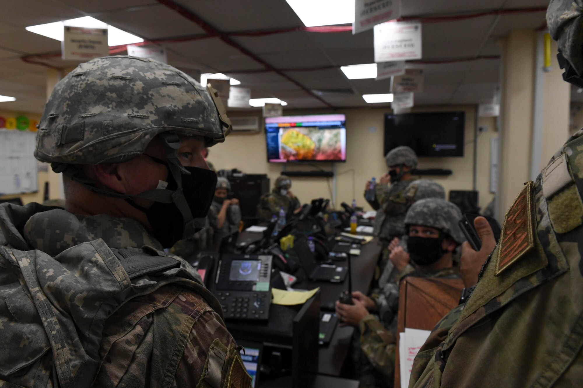 U.S. Air Force Airmen gather information in the emergency operations center during the Air and Missile Defense Exercise 21-1 at Ali Al Salem Air Base, Kuwait, Oct. 22, 2020.