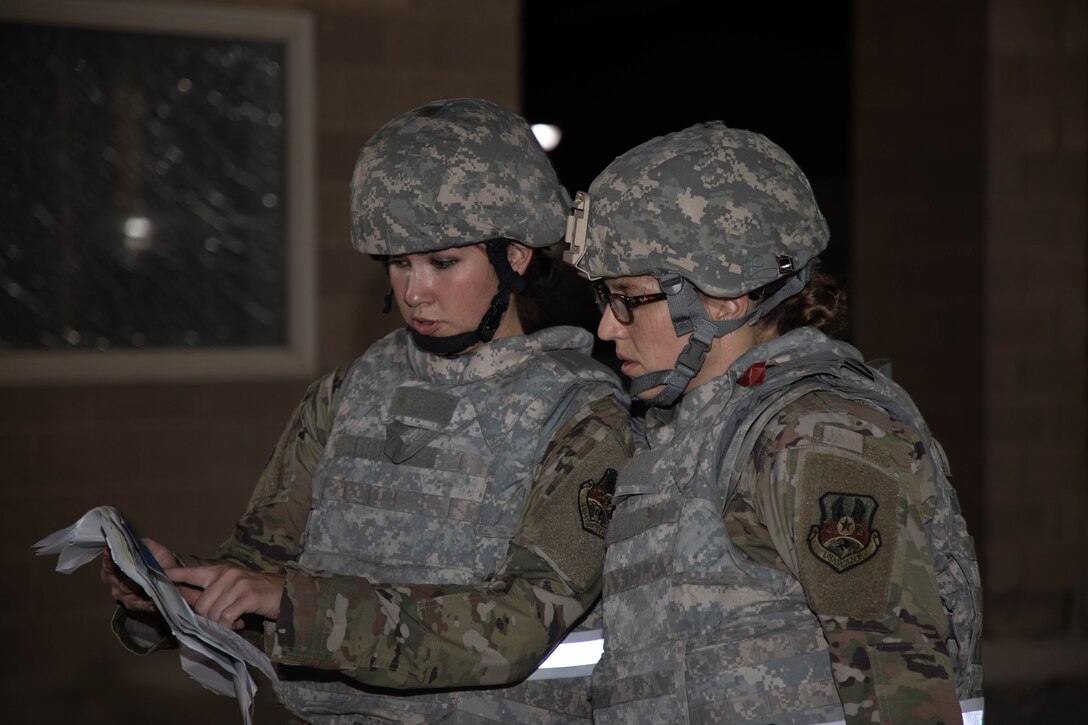 Members of the 386th Air Expeditionary Wing post attack reconnaissance team plan a safety perimeter for an unexploded ordnance during the Air and Missile Defense Exercise 21-1 at Ali Al Salem Air Base, Kuwait, Oct. 22, 2020.