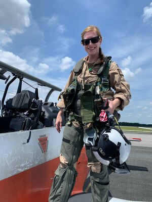 U.S. Navy Lt. Rhiannon Ross, an instructor pilot, stands in front of a T-6B Texan II primary flight trainer aircraft at Naval Air Station Whiting Field in Milton, Fla. Ross died Oct. 23, 2020, when her aircraft crashed in Foley, Alabama. (Courtesy photo)