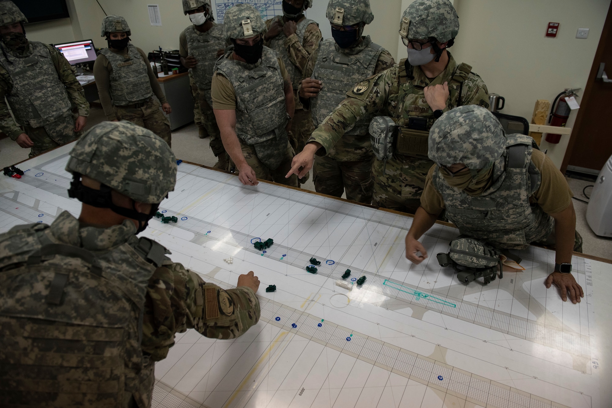 U.S. Air Force Airmen from the 386th Expeditionary Civil Engineer Squadron perform a tabletop exercise after a simulated attack during the Air and Missile Defense Exercise 21-1 at Ali Al Salem Air Base, Kuwait, Oct. 22, 2020.