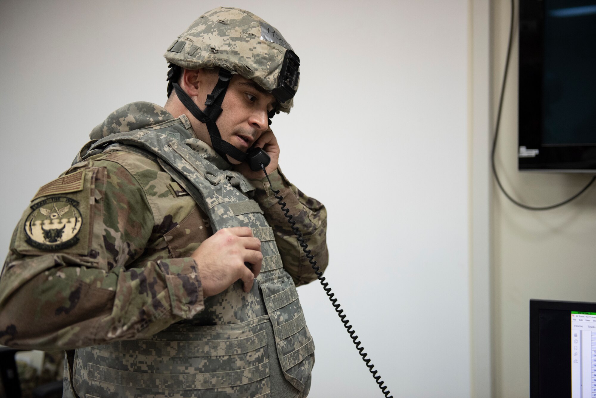 U.S. Air Force Master Sgt. Marshall Ritenour, 386th Expeditionary Civil Engineer Squadron requirements and optimization section chief, answers the phone during the Air and Missile Defense Exercise 21-1 at Ali Al Salem Air Base, Kuwait, Oct. 22, 2020.