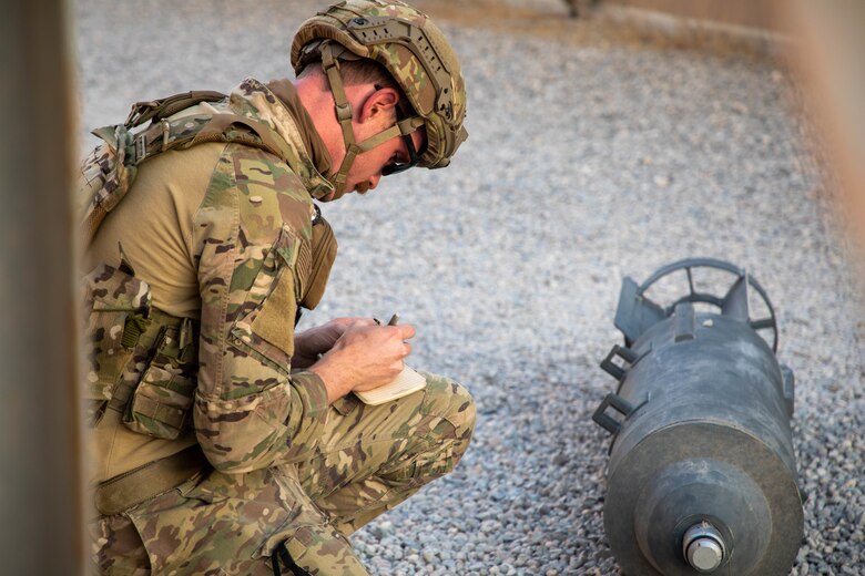 U.S. Air Force Staff Sgt. Sean Standley, 386th Expeditionary Civil Engineer Squadron explosive ordnance disposal team leader, assesses an unexploded ordnance during the Air and Missile Defense Exercise 21-1 at Ali Al Salem Air Base, Kuwait, Oct. 22, 2020.