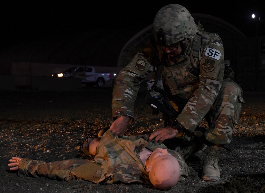 U.S. Air Force Tech. Sgt. Joshua Alvarez, 386th Expeditionary Security Forces Squadron raptor flight patrolman, assesses a dummy for injuries during the Air and Missile Defense Exercise 21-1 at Ali Al Salem Air Base, Kuwait, Oct. 22, 2020.