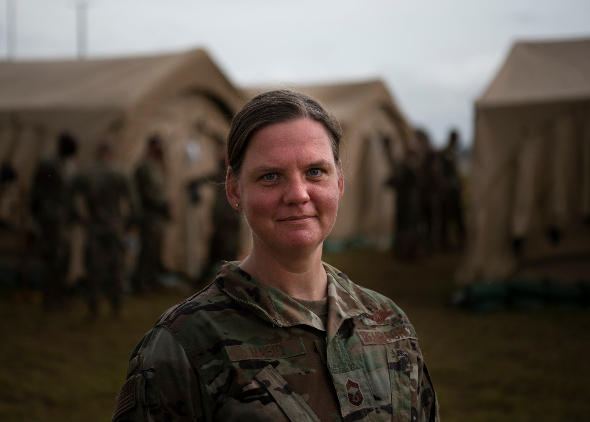 U.S. Air Force Chief Master Sgt. Emily Masic, 366th Fighter Wing superintendent, stands in front of the mobile operating base for Agile Flag 21-1, at Tyndall Air Force Base, Florida, Oct. 24, 2020. Masic's role throughout the exercise is tie everyone together in the A-staff to ensure mission success.  When problems arise, she is able to connect Airman to Airman to expedite the problem solving process. (U.S. Air Force photo by Senior Airman Andrew Kobialka)