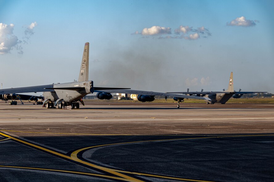 A U.S. Air Force Reserve C-130H Hercules aircraft assigned to the 910th Airlift Wing, based at Youngstown Air Reserve Station, Ohio and equipped with a Modular Aerial Spray System, taxis past a B-52 Stratofortress bomber prior to taking off at Barksdale Air Force Base, Louisiana, Oct. 22, 2020.