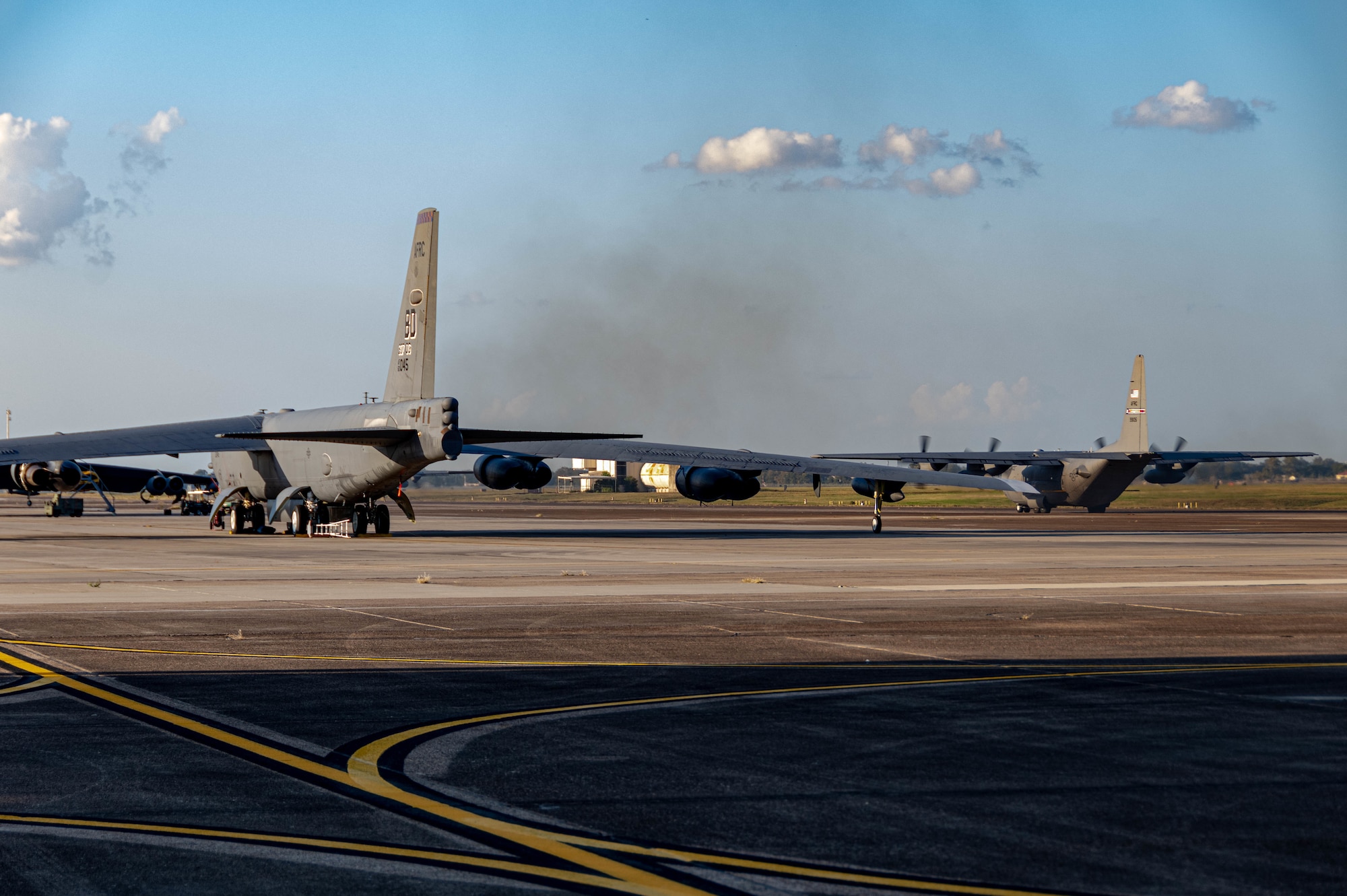 A U.S. Air Force Reserve C-130H Hercules aircraft assigned to the 910th Airlift Wing, based at Youngstown Air Reserve Station, Ohio and equipped with a Modular Aerial Spray System, taxis past a B-52 Stratofortress bomber prior to taking off at Barksdale Air Force Base, Louisiana, Oct. 22, 2020.