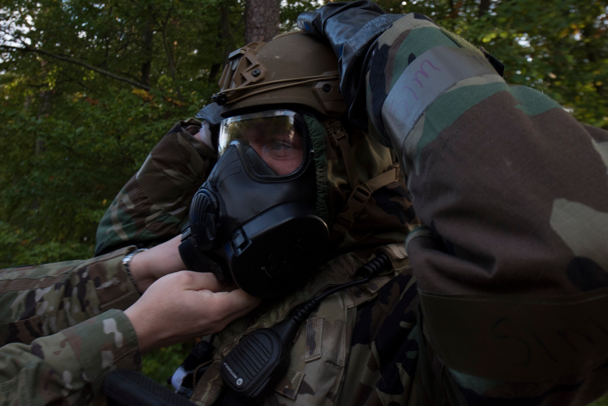 An Airman adjusts his chemical gear.