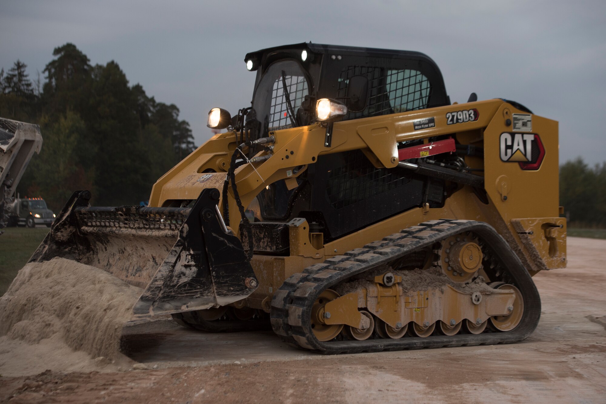An Airman clears a destroyed segment of a mock runway.