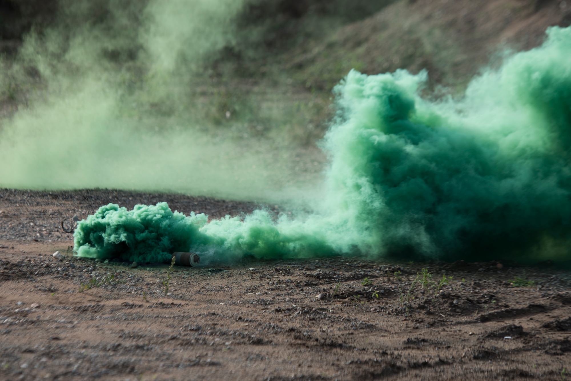 A smoke grenade canister is set off.