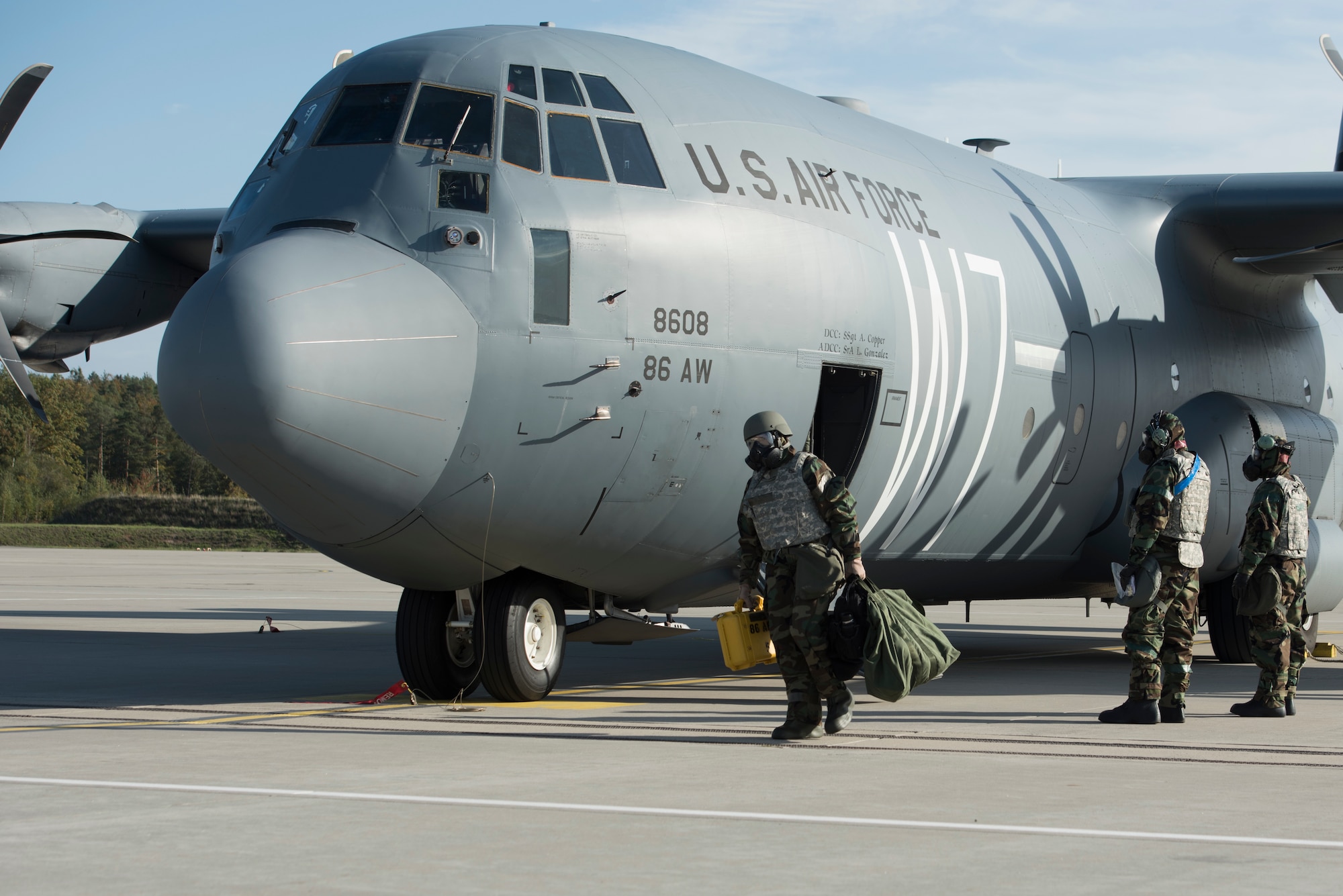 An Airman departs from a C-130J Hercules aircraft.