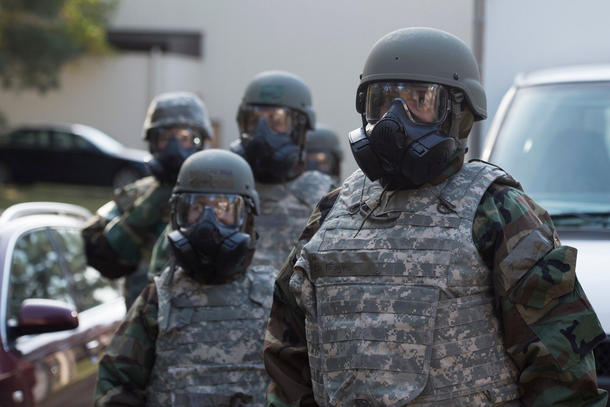 An Airmen waits for further instruction in a simulated decontamination line.