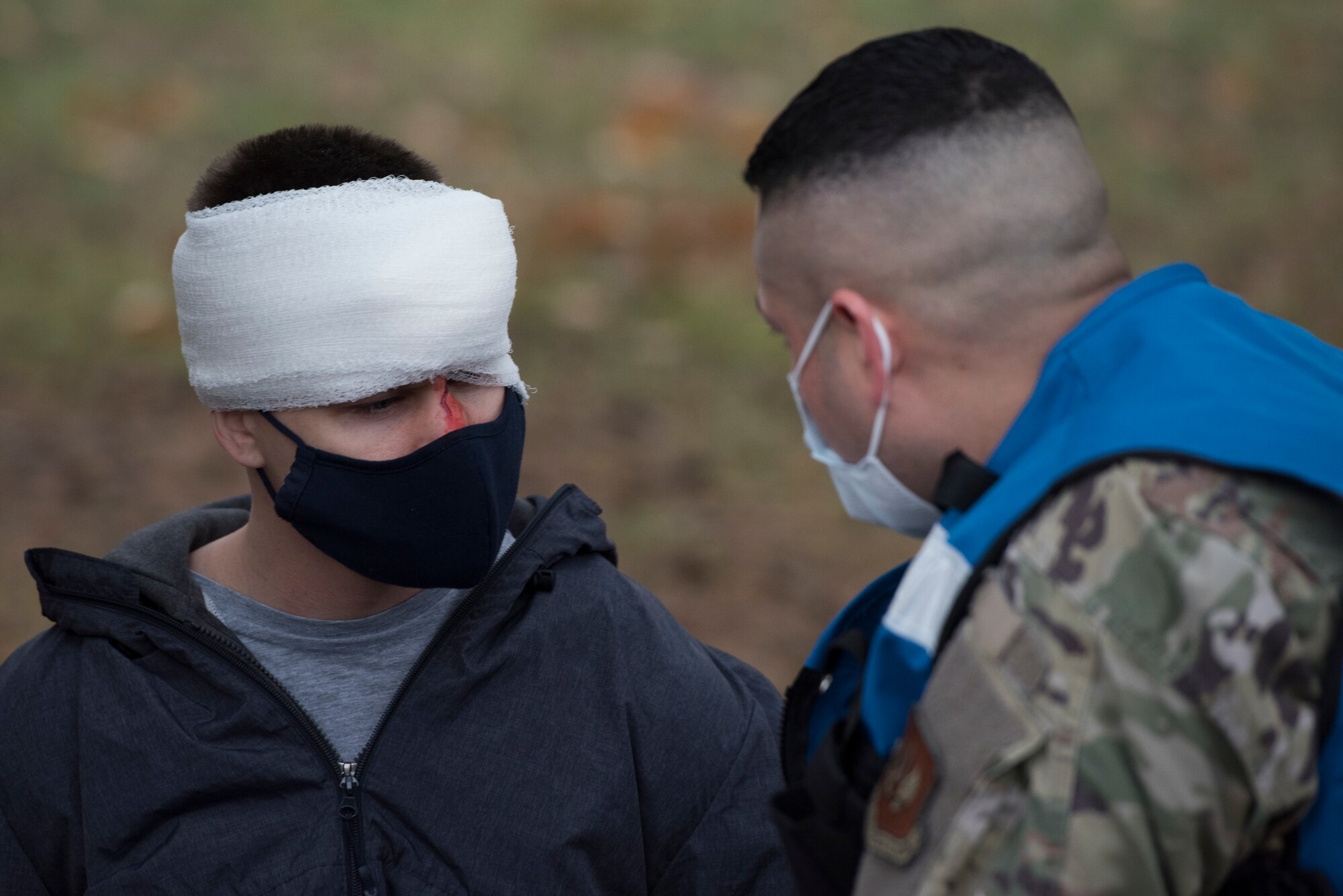 An Airmen speaks with a simulated victim.