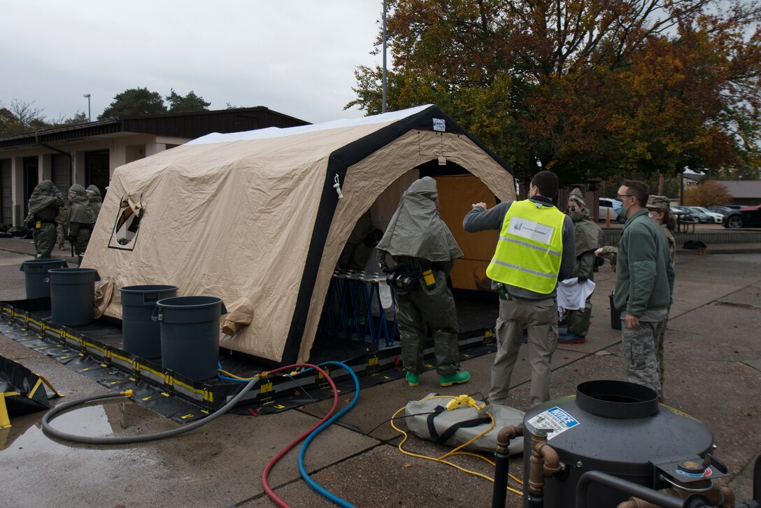Airmen use a decontamination tent.