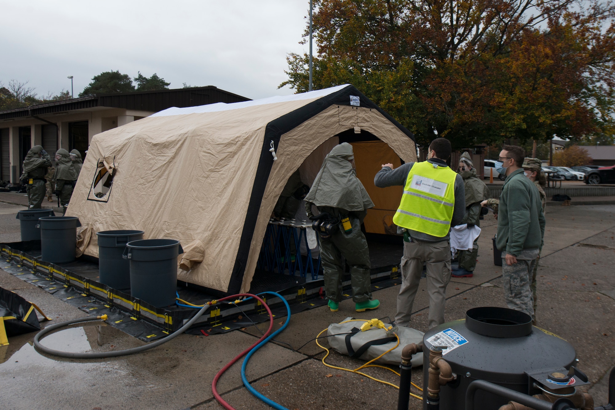 Airmen use a decontamination tent.
