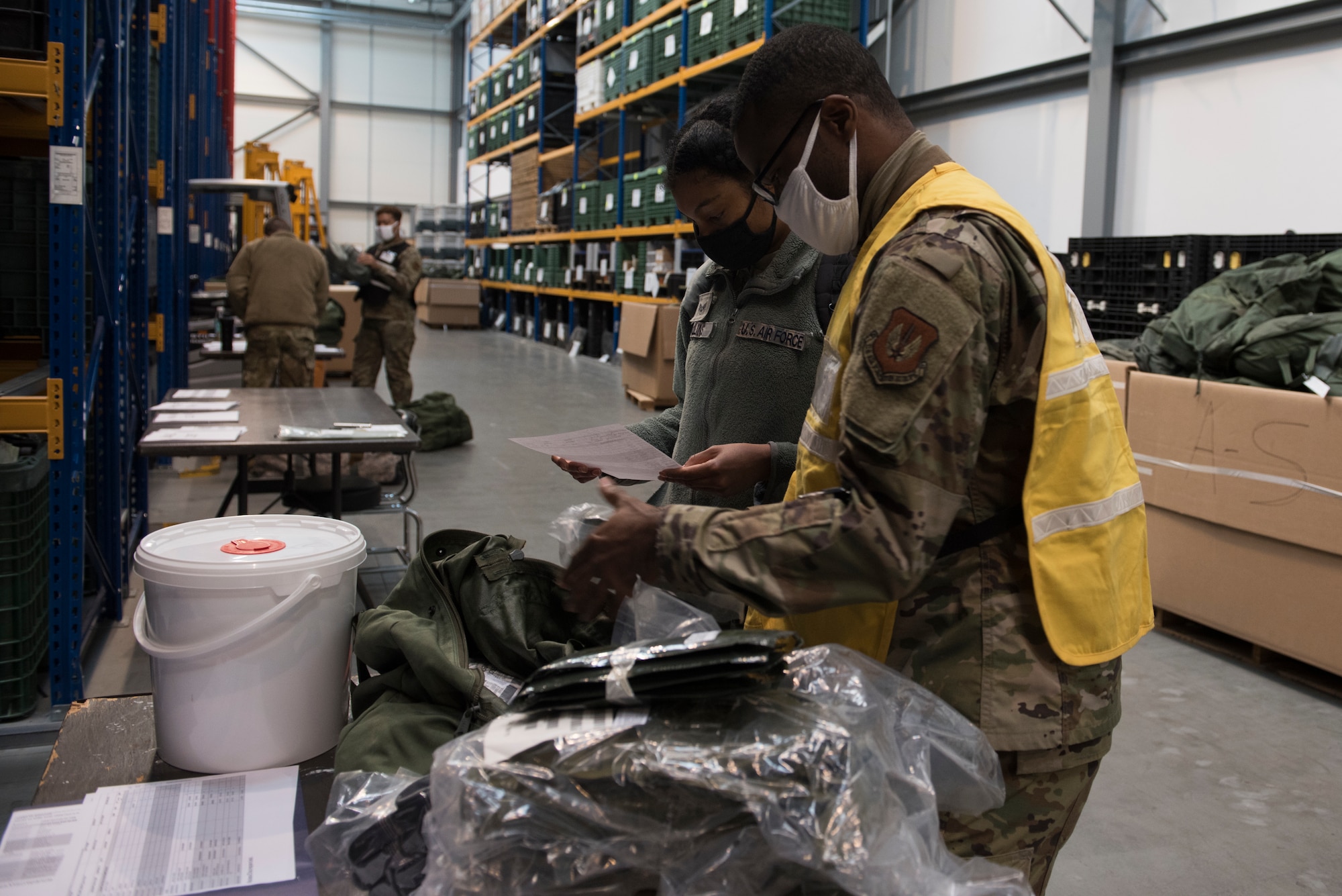 Airmen examine training equipment.