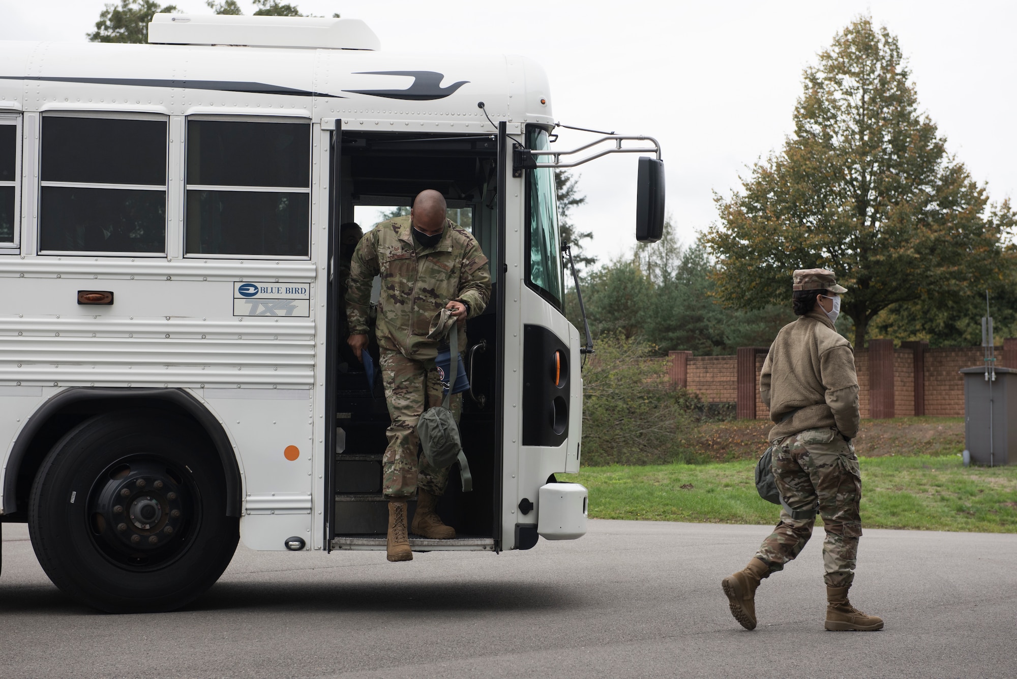 U.S. Airmen disembark a bus.