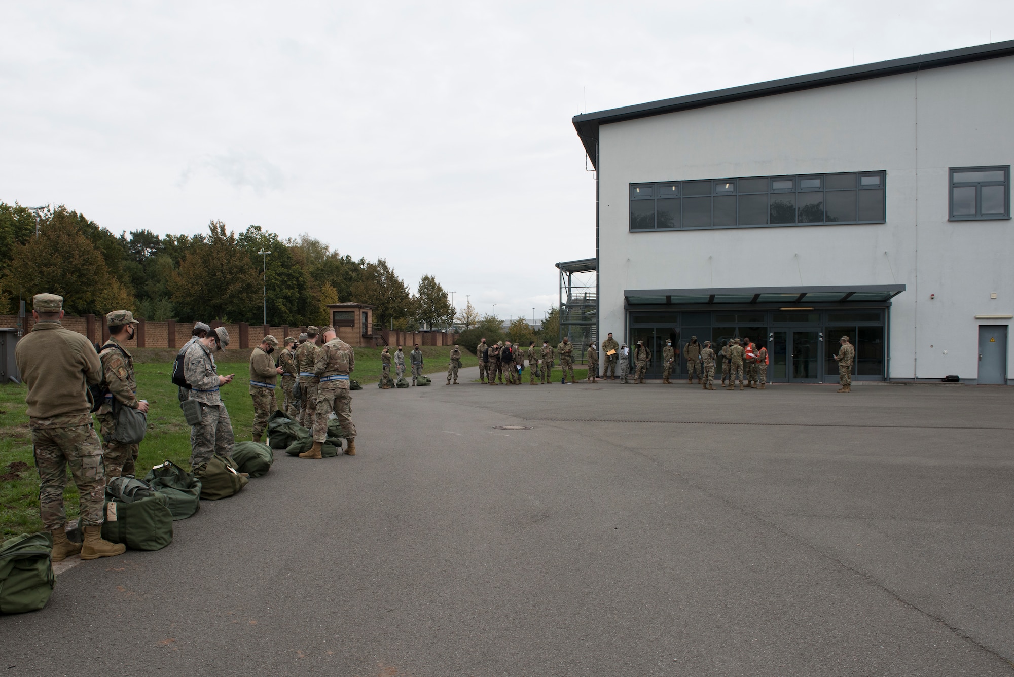 Airmen wait for further instruction in a simulated pre-deployment line.